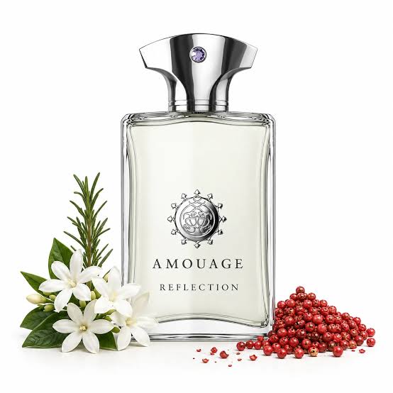 Amouage Reflection perfume bottle with a silver cap, shown on a white background with white flowers, green leaves, and red berries as scent notes.