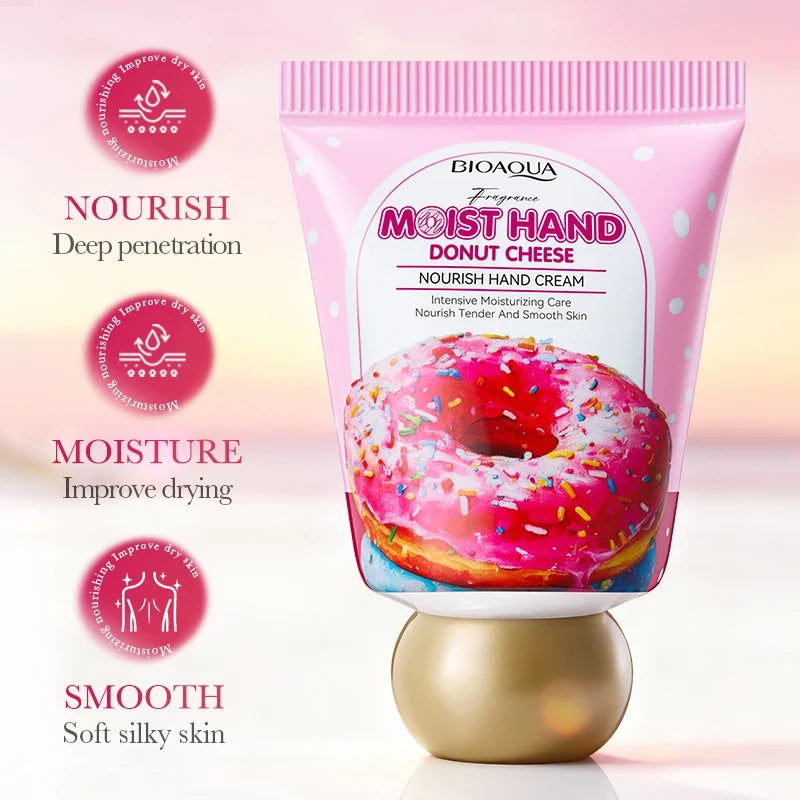 BIOAQUA Moist Hand Cream in a pink squeeze tube with a donut graphic and a metallic gold cap, shown on a soft pink background with three benefit callouts on the left.