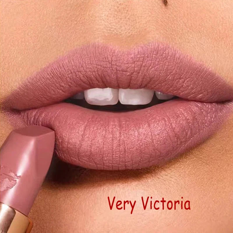 Close-up of a lip with pink lipstick labeled 'Very Victoria' on a beige background