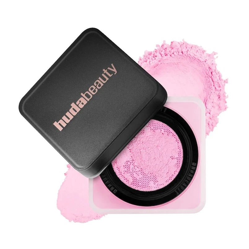 Huda Beauty compact with pink powder on a white background