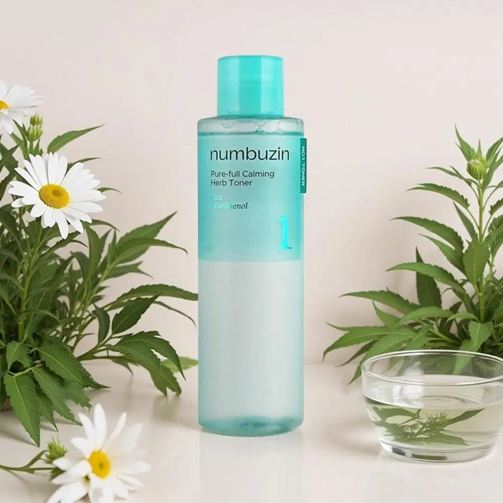 Numbuzin toner bottle with plants and a glass of water on a light background