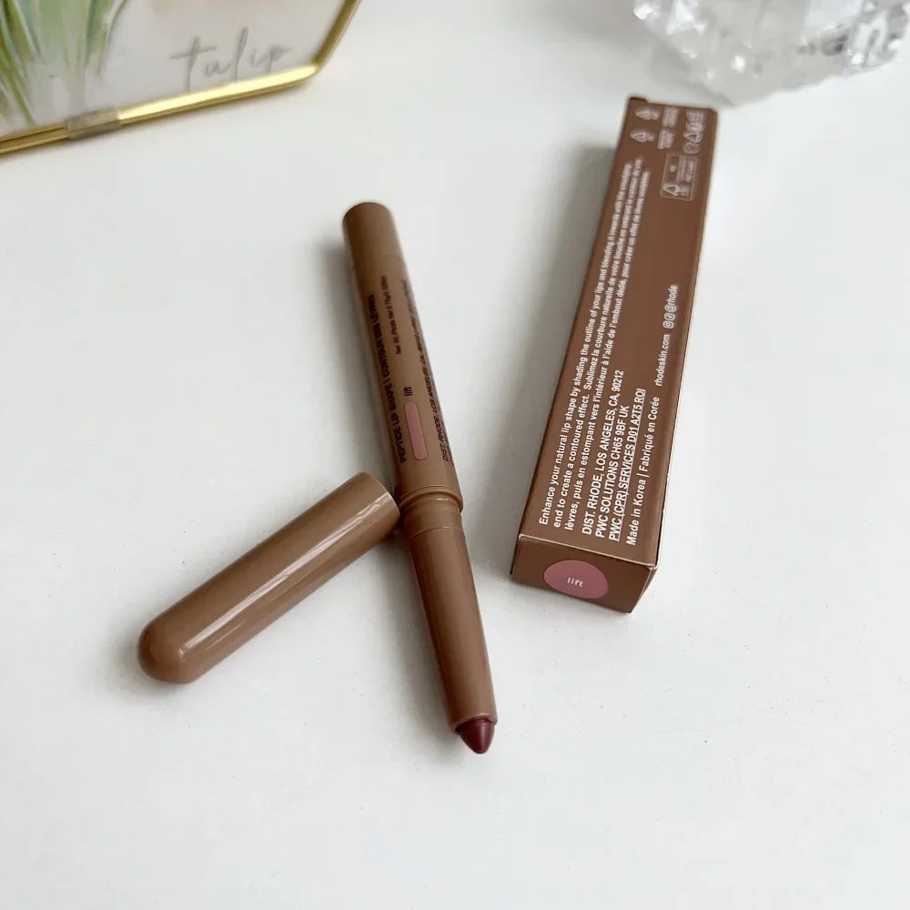 Brown lip liner with packaging on a white surface