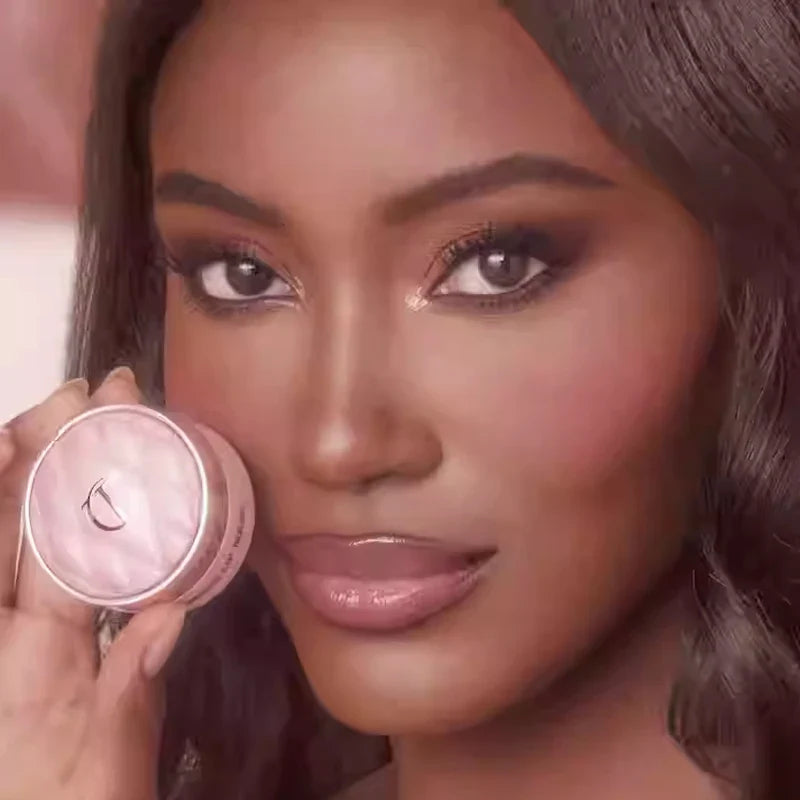 Woman holding a pink makeup compact with a blurred background